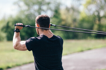 Strength training concept. Strong man doing back exercises using