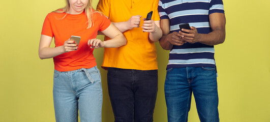 Group of friends using mobile smartphones. Teenagers addiction to new technology trends. Close up. Millenials texting, scrolling, chatting, watching video or shopping online. Connecting with devices.
