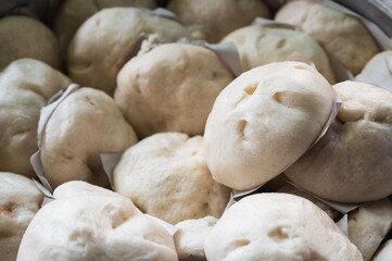 Homemade steamed pork buns in a steamer