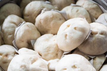 Homemade steamed pork buns in a steamer