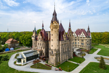 Fototapeta premium Fabulous historic castle in Moszna near Opole, Silesia, Poland. Built in XVII century, extended from 1900 to 1914. One of the best known and most beautiful monuments in Upper Silesia. Aerial view