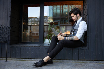 Young handsome man sitting and working on laptop