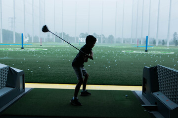 golf player swing in an outdoor drive range 
