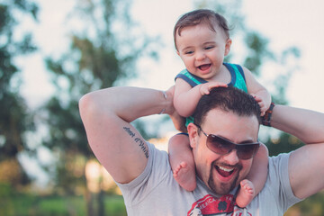 father and son on fathers shoulders day stock photo royalty free