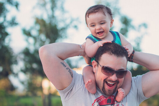 father and son on fathers shoulders day stock photo royalty free