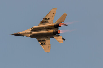 Air force jet fighter showing afterburner flames during aerobatic display
