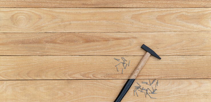 Hammer and nails on a wooden background. Copy space