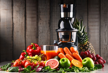 Slow juicer with organic fruits and vegetables.