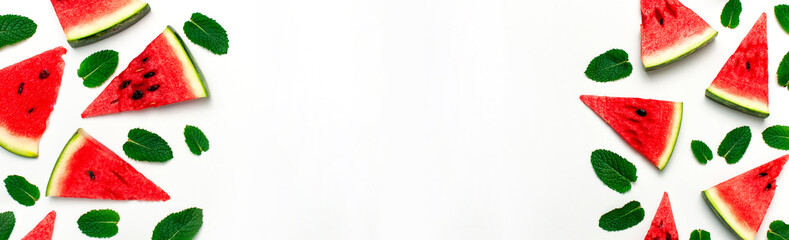 Creative summer food concept. Watermelon pattern. Juicy slices of ripe red watermelon and mint leaves on white background. Flat lay, top view, copy space. Summer berry, healthy nutrition, vitamins