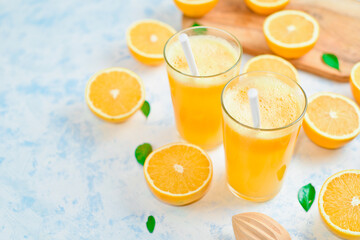 fresh orange Juice and oranges on the cutting board
