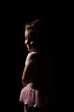 Little Ballerina Girl in Black Background 