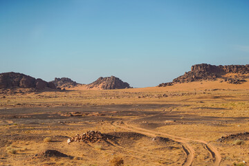 Fototapeta na wymiar bleak desert landscape with mountain and rock formations