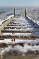 Snow-covered staircase. Stand for skiing and snowboards