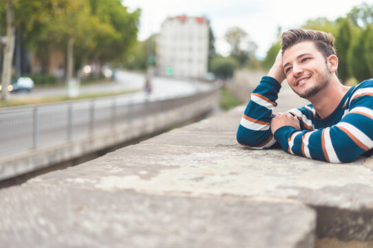 Positive thinkful man enjoying on the street, outdoors.