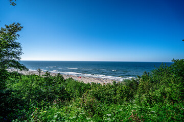 Fototapeta na wymiar Sunny beach by the sea. Blue sky