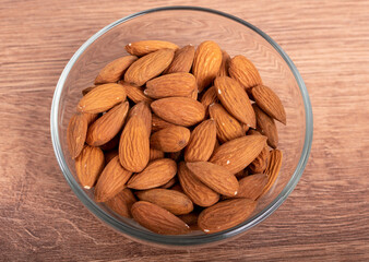 almonds in bowl on wooden table