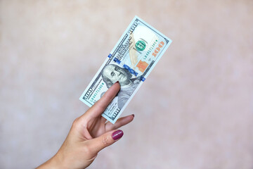 Banknote is between the fingers. Woman hand.