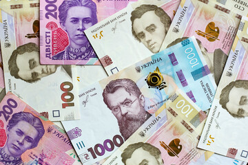 Straggling couple of Ukrainian banknotes. Financial presentation background.