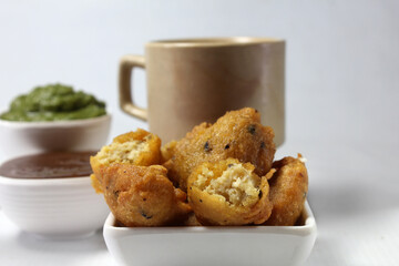 Moong Dal Vada or pakoda/pakora /fritters is Indian  deepfried streetfood served hot with spicy and tangy chutney and tea.