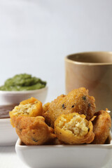 Moong Dal Vada or pakoda/pakora /fritters is Indian  deepfried streetfood served hot with spicy and tangy chutney and tea.