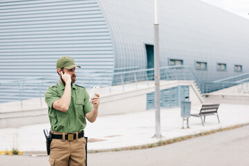 Obraz premium security guard in uniform and armed working on the safety of buildings