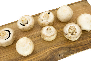champignons on a wooden board on white