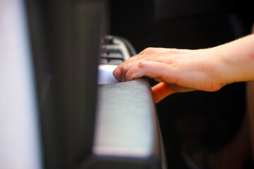 Person hand on car interior door handle