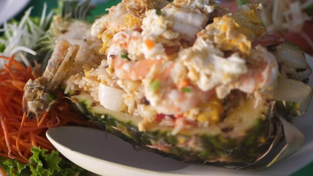 Delicious hot spicy food, rice in pineapple with shrimp and papaya salad. HD, 1920x1080, slow motion