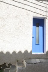 Obraz na płótnie Canvas Blue door on white house.