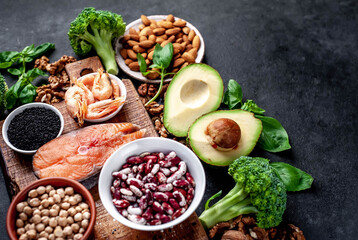 Fototapeta na wymiar Omega-3 food sources. Foods high in fatty acids, including seafood, vegetables, nuts and seeds on a stone background