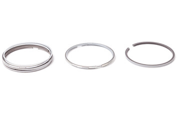 Repair kit for three piston engine rings of chromed metal on a white isolated background in a photo...