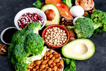 Omega-3 food sources. Foods high in fatty acids, including seafood, vegetables, nuts and seeds on a stone background