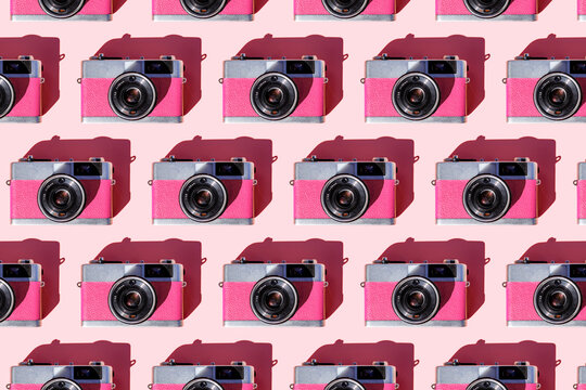 Seamless pattern of rows of vintage analog cameras