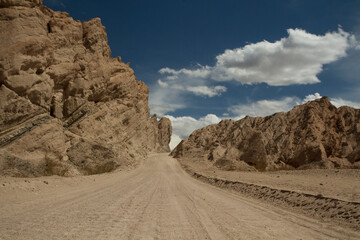 Traveling along route 40. Dirt road across the arid desert and sandstone in Quebrada de las Flechas, Salta Argentina.