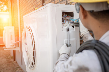 Air Conditioning Technician and A part of preparing to install new air conditioner. Technician...