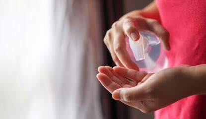 Woman using alcohol sanitizer gel rub for cleaning hand COVID-19 corona virus prevention concept