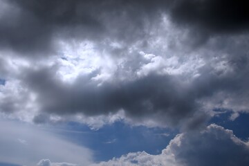 Obraz premium storm clouds obstruct the sun on blue sky