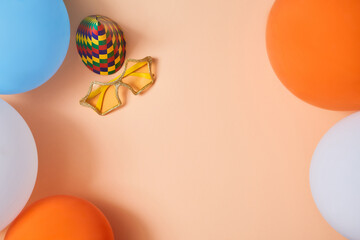 Celebration background. Children party. Happy birthday concept. Top view of holiday cap, funny glasses and balloons