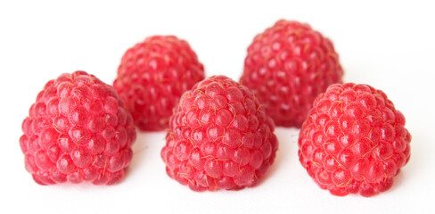 Large juicy raspberries on a white background.