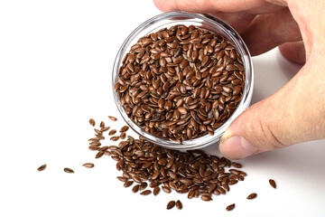 flaxseeds in a glass container isolated on a white background. proper nutrition and weight loss