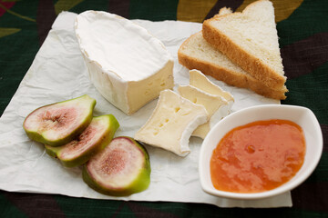 Appetizers table with snacks. Brie cheese, ham, bread, jam. Option for Breakfast