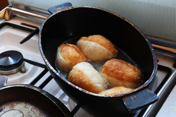 making deep-fried pastry pies in the kitchen