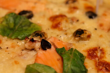 Pizza with seafood close-up of the oven