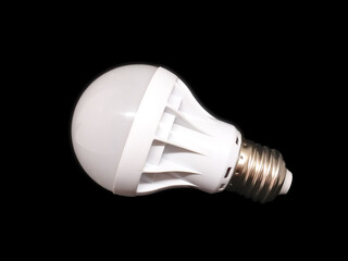 White LED lamp, isolate on a black background. Concept: environmental friendliness, energy saving, modern technologies.