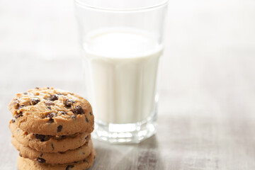 milk and cookies on wooden table