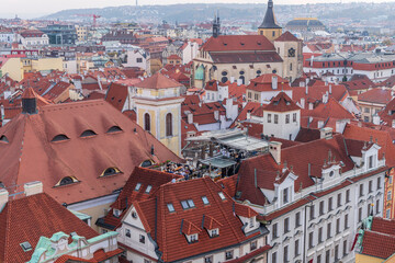 Aerial view of citycape of old town of Prague, with a lot of red rooftops and churches