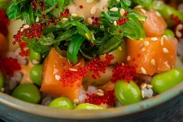 Salmon sashimi spicy salad on black dish in the restaurant (Japanese food)