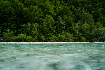 Obraz na płótnie Canvas Calm blue water river crossing the countryside landscape, Slovenia.