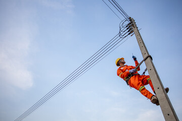 Electricians are climbing on electric