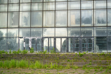 abandoned shopping center building with a glass facade